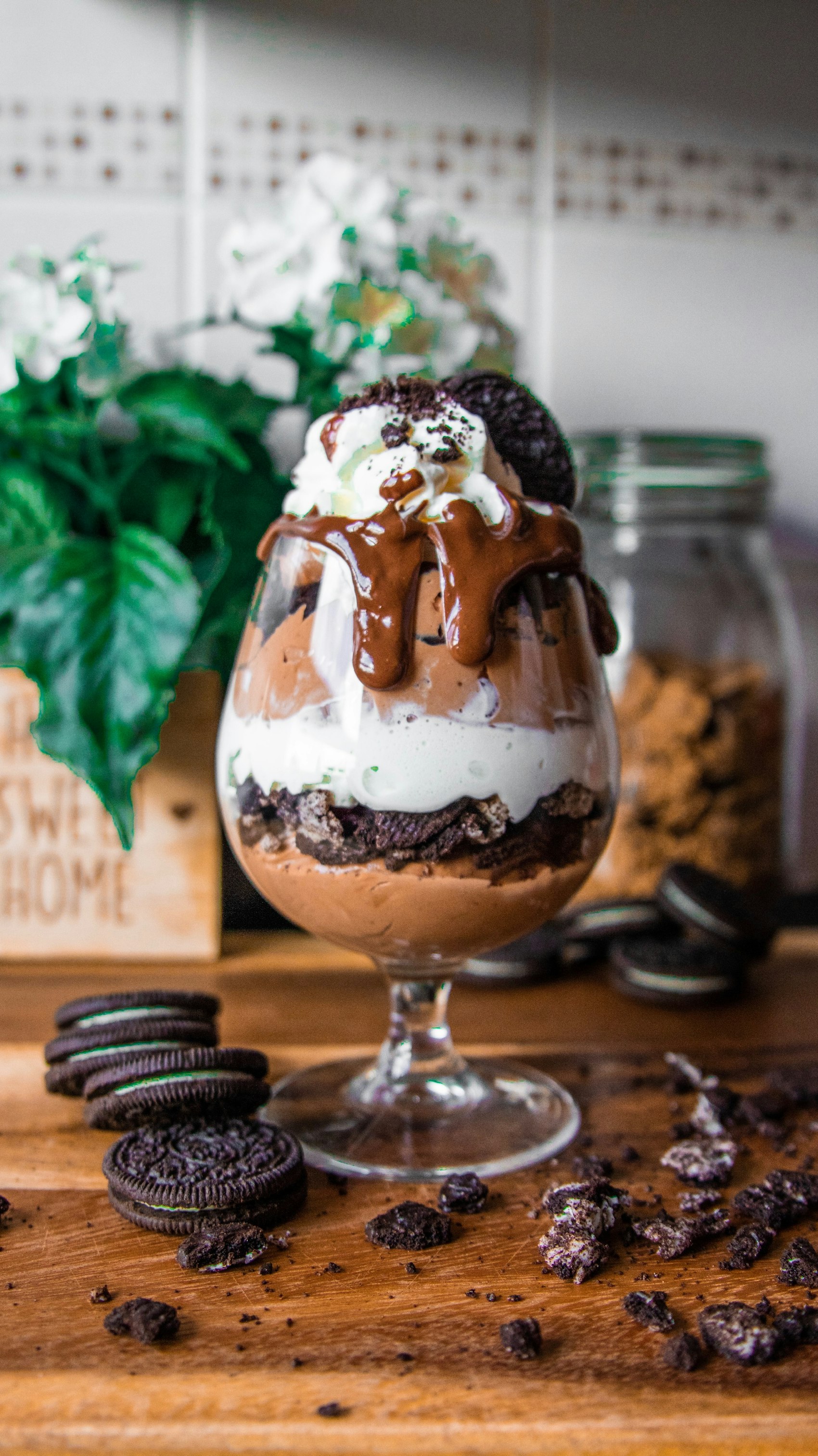 A tall chocolate Oreo sundae glass layered with mousse, cream and fudge, crowned with a cookie at Cloud Nine.